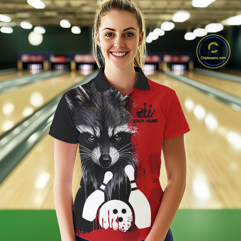 Woman wearing a black and red raccoon bowling polo shirt at a bowling alley front view.