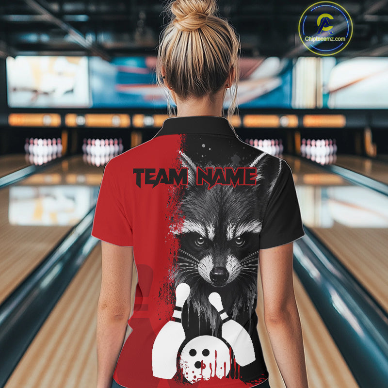 Back view of woman wearing a black and red raccoon bowling polo shirt inside a bowling alley.