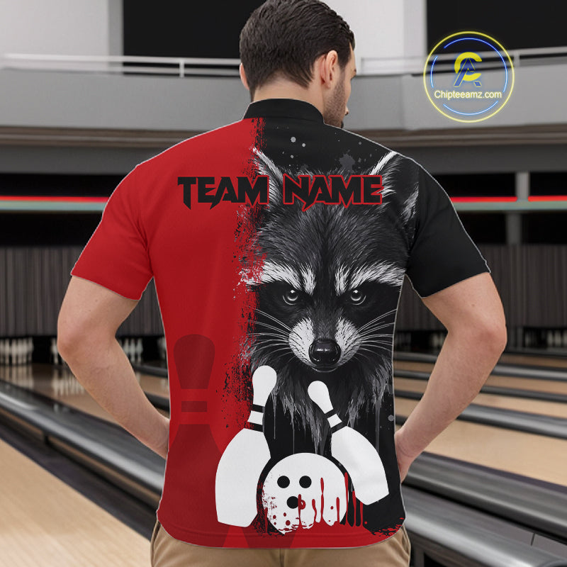Back view of man wearing a black and red raccoon bowling quarter zip shirt in a bowling alley.