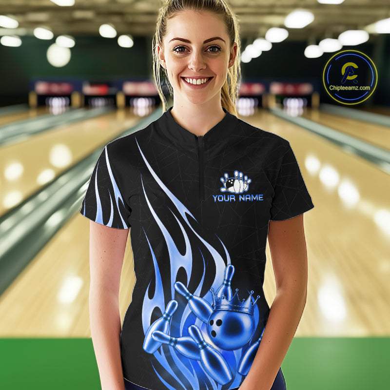 Woman wearing a black and blue bowling ball crown quarter zip bowling shirt front view.