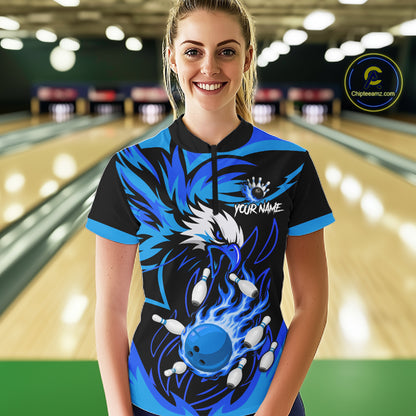 Woman wearing black and blue flame eagle bowling quarter zip shirt front view.