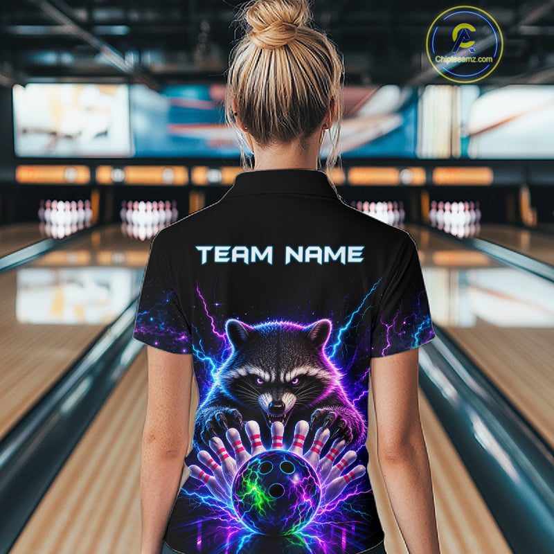 Back view of woman wearing a neon raccoon bowling polo shirt inside a bowling alley.