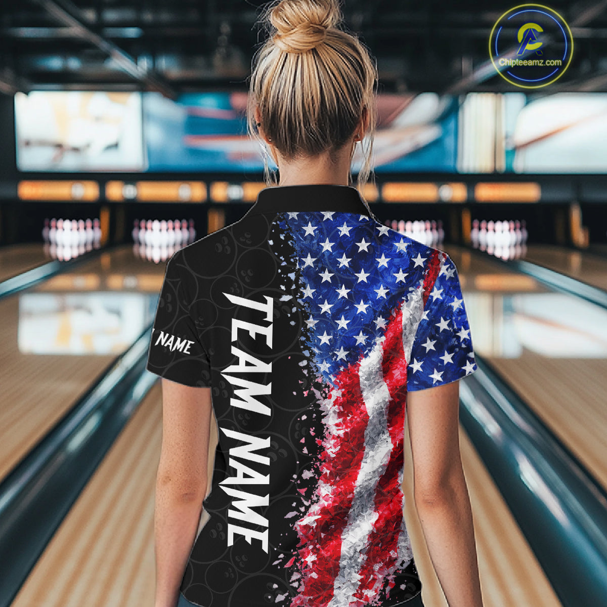 Back view of woman wearing an American flag bowling polo shirt inside a bowling alley.